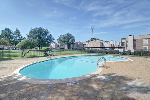 pool featuring a residential view and fence