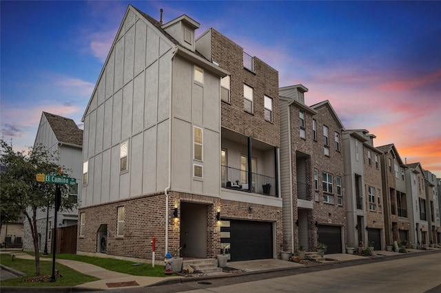 property at dusk featuring a garage