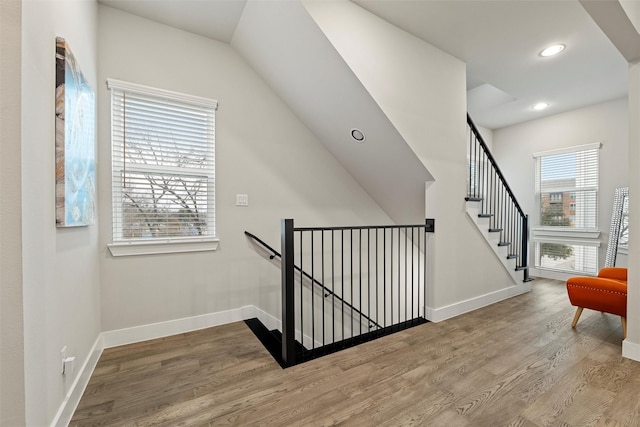 interior space featuring recessed lighting, wood finished floors, and baseboards