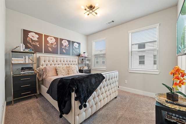 carpeted bedroom with visible vents and baseboards