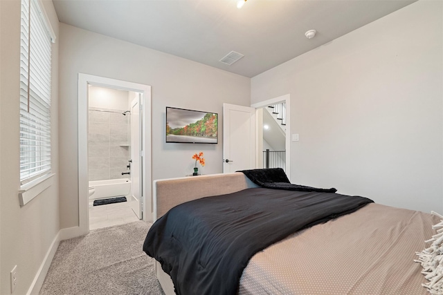 carpeted bedroom featuring baseboards and visible vents