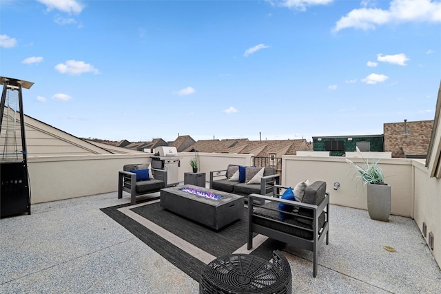 view of patio featuring an outdoor living space with a fire pit and a balcony