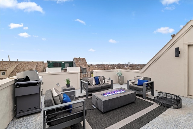 view of patio with area for grilling and an outdoor living space with a fire pit