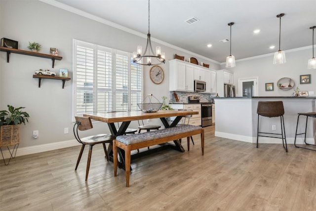 dining area with baseboards, visible vents, ornamental molding, an inviting chandelier, and light wood-style floors