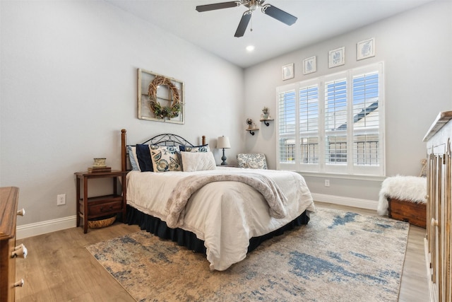 bedroom with ceiling fan, recessed lighting, wood finished floors, and baseboards