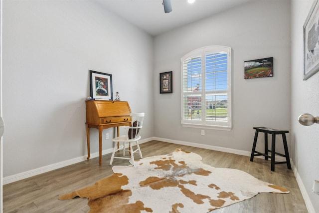 office space featuring ceiling fan, wood finished floors, and baseboards