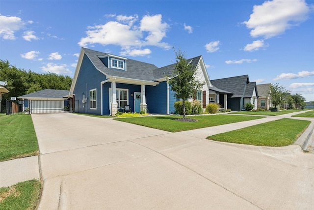 view of front facade featuring a gate, fence, a front lawn, and a detached garage