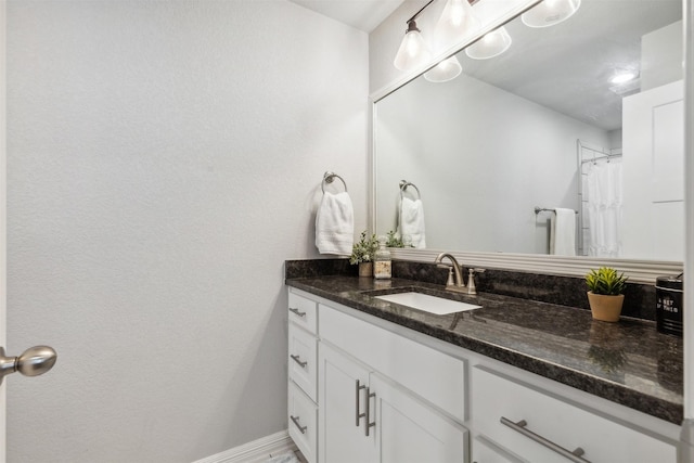 bathroom with vanity and baseboards