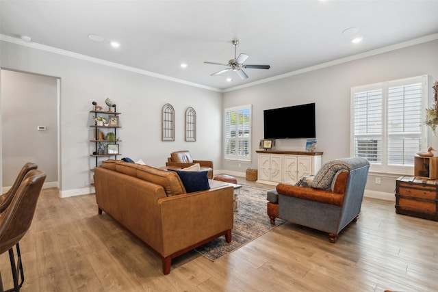 living room featuring light wood-type flooring, a healthy amount of sunlight, and baseboards