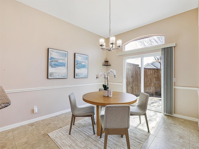 dining space featuring an inviting chandelier, baseboards, and light tile patterned flooring