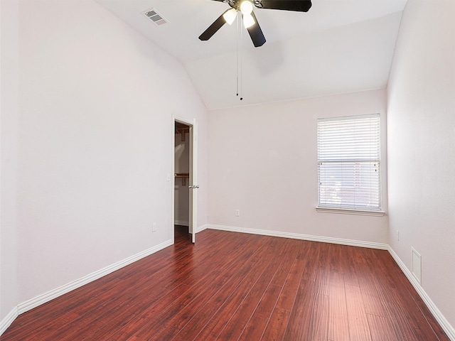 spare room with a ceiling fan, baseboards, vaulted ceiling, and wood finished floors