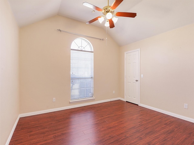 empty room featuring lofted ceiling, ceiling fan, baseboards, and wood finished floors