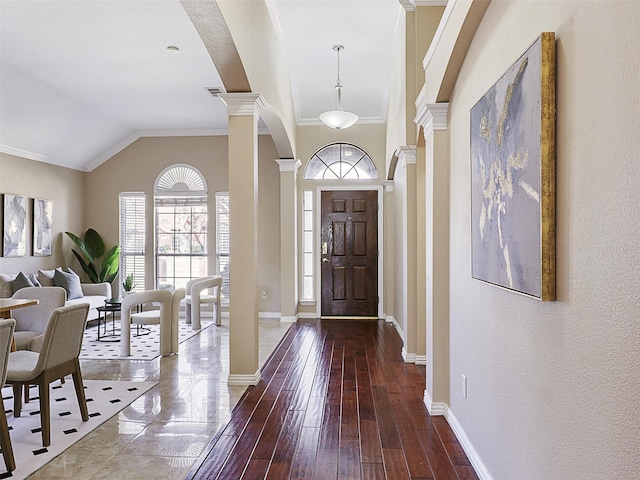 entryway with ornamental molding, dark wood-style flooring, baseboards, and ornate columns