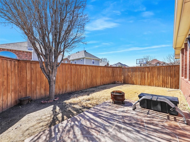 view of patio featuring an outdoor fire pit and a fenced backyard