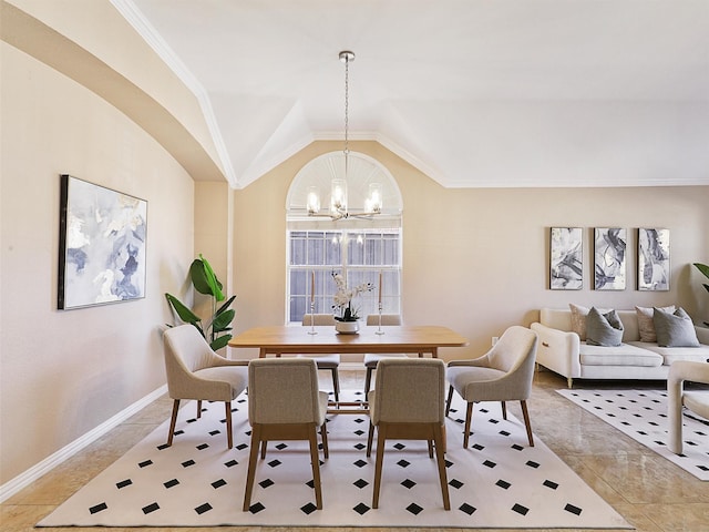 dining area with lofted ceiling, baseboards, a chandelier, and ornamental molding