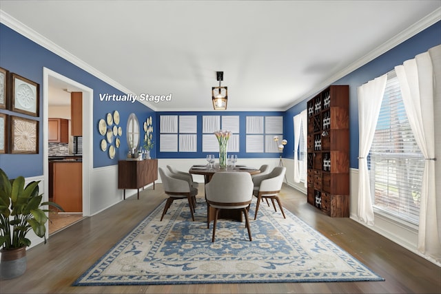 dining area featuring ornamental molding and dark wood-type flooring