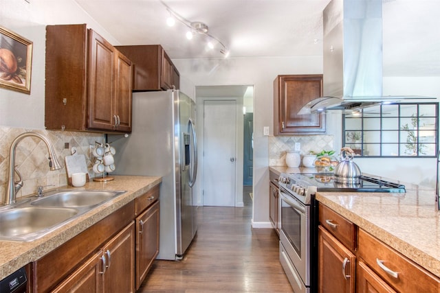 kitchen with island range hood, stainless steel appliances, a sink, light countertops, and dark wood-style floors