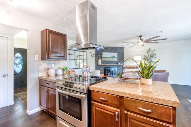 kitchen featuring tasteful backsplash, dark wood-type flooring, island exhaust hood, and stainless steel range with electric cooktop