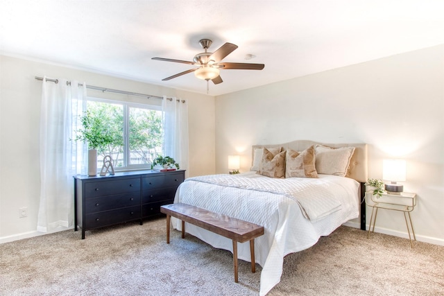 bedroom with a ceiling fan, baseboards, and carpet flooring