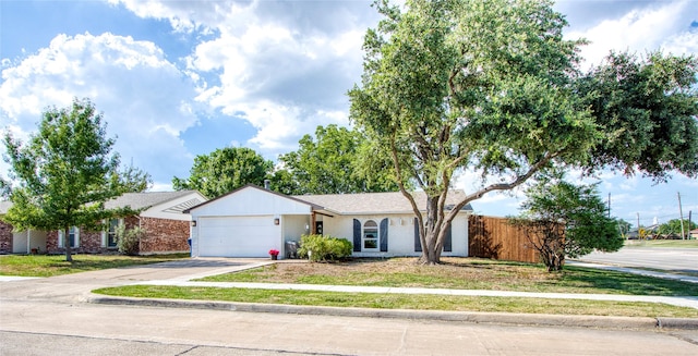 ranch-style home with a garage, driveway, fence, and brick siding