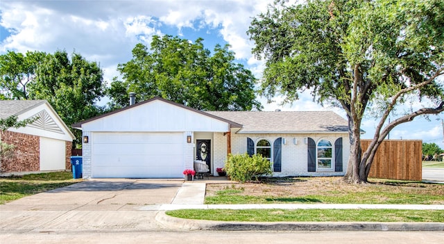 ranch-style home featuring a garage, driveway, brick siding, and roof with shingles