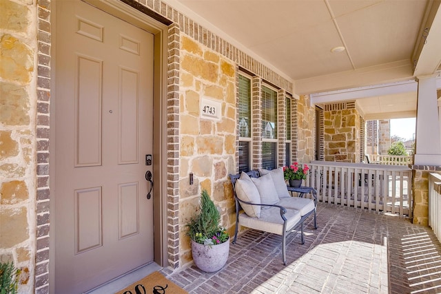 view of exterior entry with covered porch