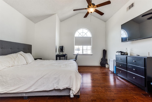 bedroom featuring baseboards, visible vents, a ceiling fan, lofted ceiling, and wood finished floors