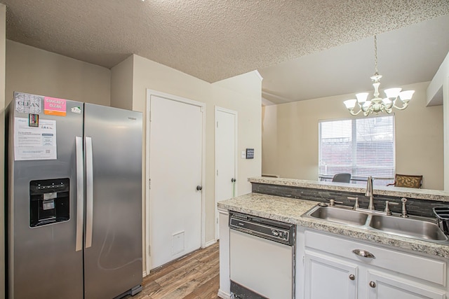 kitchen featuring stainless steel refrigerator with ice dispenser, light wood-style floors, white cabinets, a sink, and dishwasher