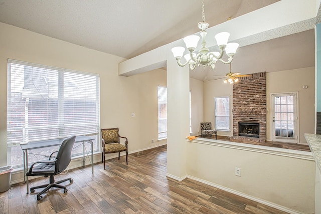 home office with lofted ceiling, a fireplace, and wood finished floors