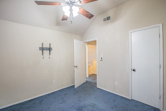 unfurnished bedroom featuring baseboards, visible vents, a ceiling fan, vaulted ceiling, and carpet flooring