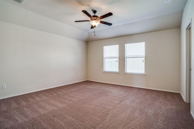 spare room featuring carpet, a ceiling fan, and baseboards
