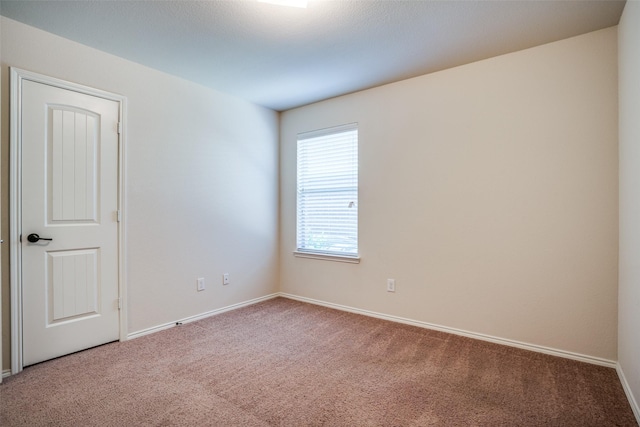 spare room with carpet floors and baseboards