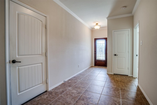 entrance foyer featuring ornamental molding, tile patterned flooring, and baseboards