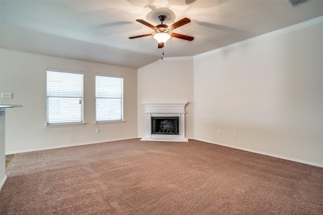 unfurnished living room with a fireplace with raised hearth, carpet flooring, a ceiling fan, baseboards, and crown molding