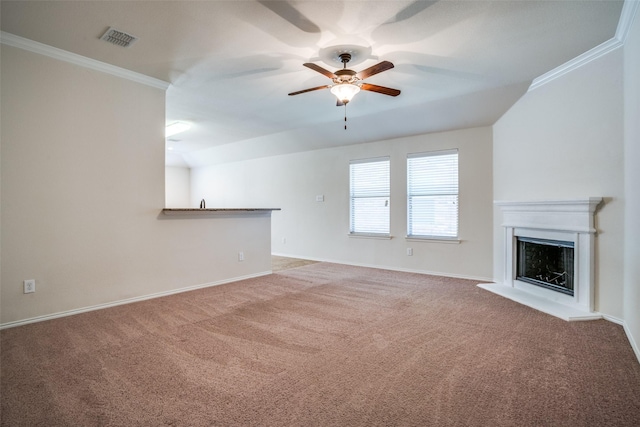 unfurnished living room with carpet, a fireplace with raised hearth, a ceiling fan, and ornamental molding