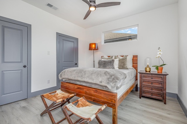 bedroom with ceiling fan, baseboards, visible vents, and light wood-type flooring