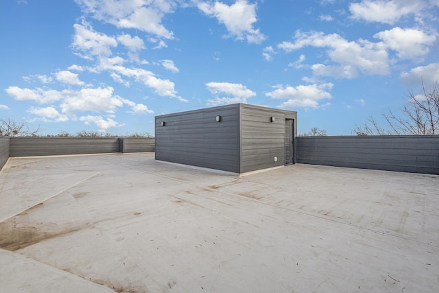 view of outbuilding with fence