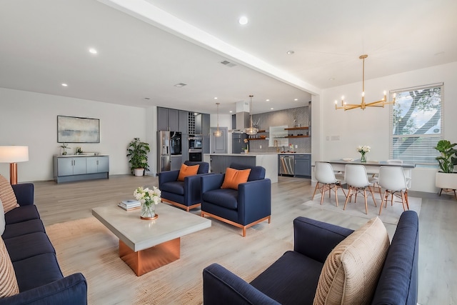 living room with a chandelier, recessed lighting, and light wood finished floors