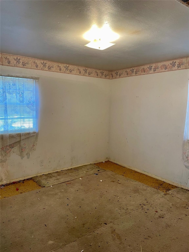 spare room featuring a textured ceiling