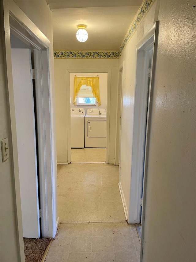 hallway featuring washing machine and dryer and light floors