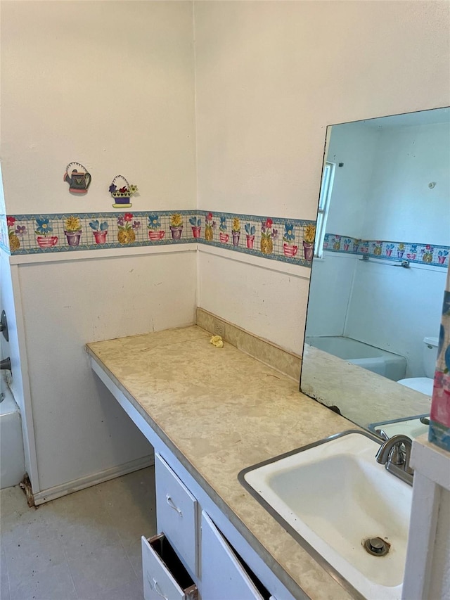 bathroom featuring vanity and a bath