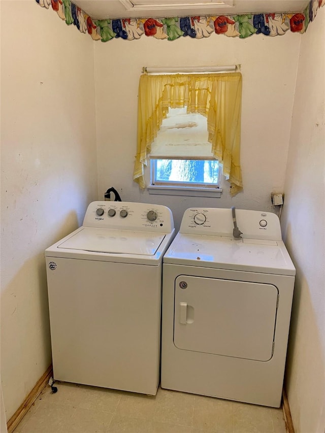 laundry area featuring laundry area, baseboards, and separate washer and dryer