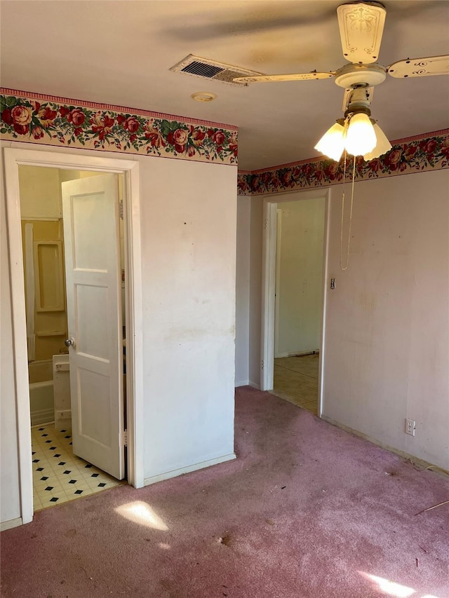 empty room with ceiling fan and light colored carpet