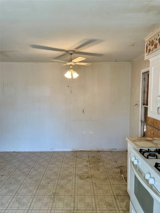 empty room with light floors and a ceiling fan