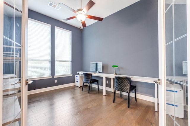 office area featuring baseboards, visible vents, ceiling fan, and wood finished floors