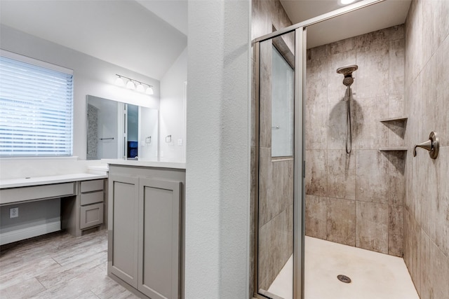 bathroom featuring a shower stall and vanity