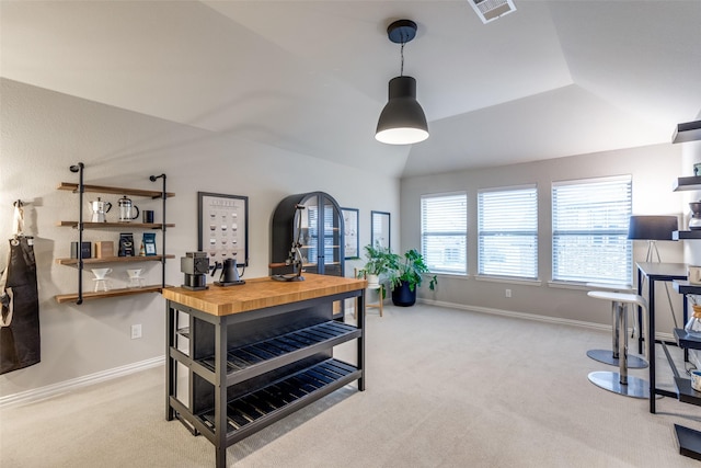 office space featuring lofted ceiling, carpet floors, visible vents, and baseboards