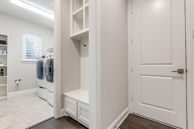 laundry room with washer and dryer, laundry area, dark wood finished floors, and baseboards