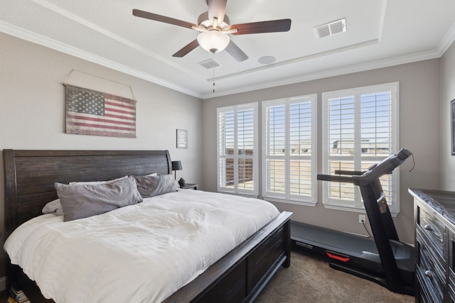 bedroom with multiple windows, visible vents, dark carpet, and ornamental molding