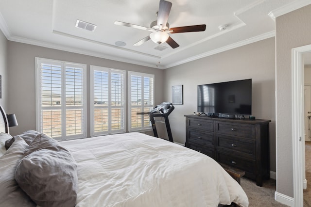 bedroom with carpet floors, ornamental molding, visible vents, and a ceiling fan